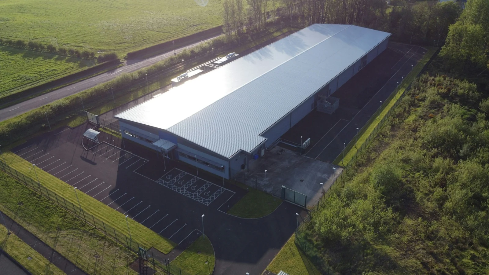 A data centre campus seen from the air. The building is the cheap part; the connection into it is not.