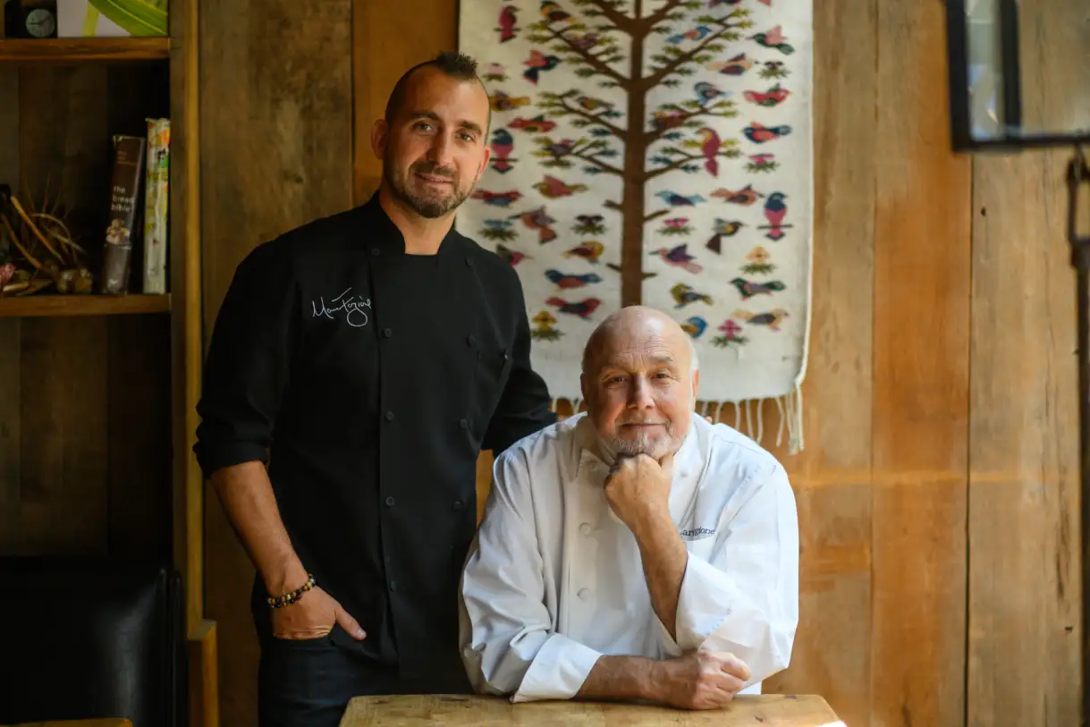 Father and son Marc Forgione and Larry Forgione pose together in a photo