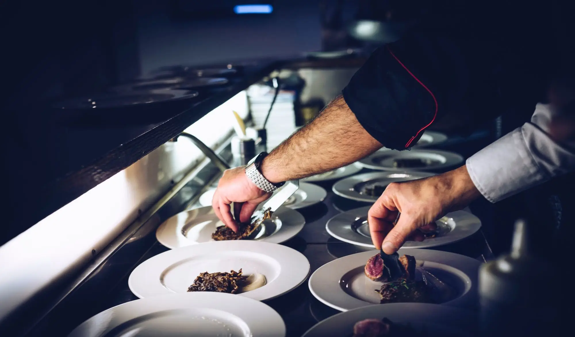 a man cutting food on a plate