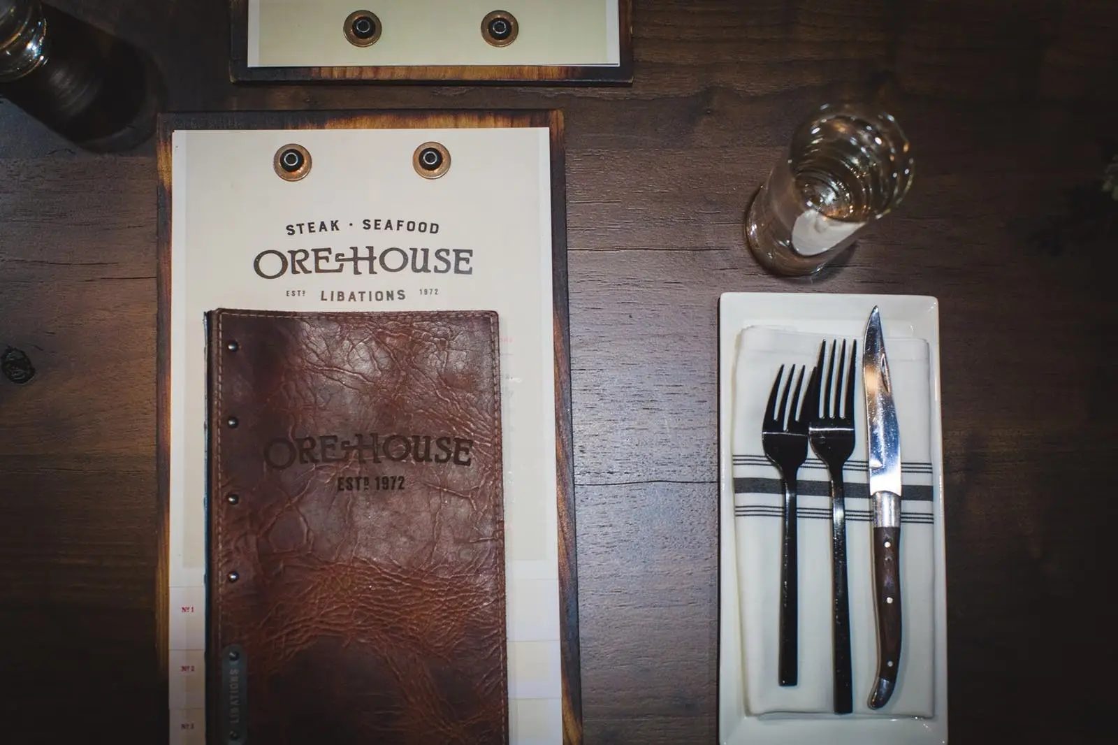 Ore House's printed menus next to table setting