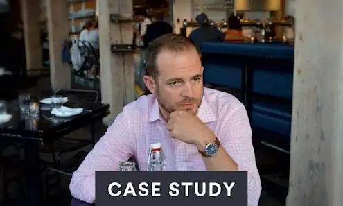 a man sitting at a table eating food