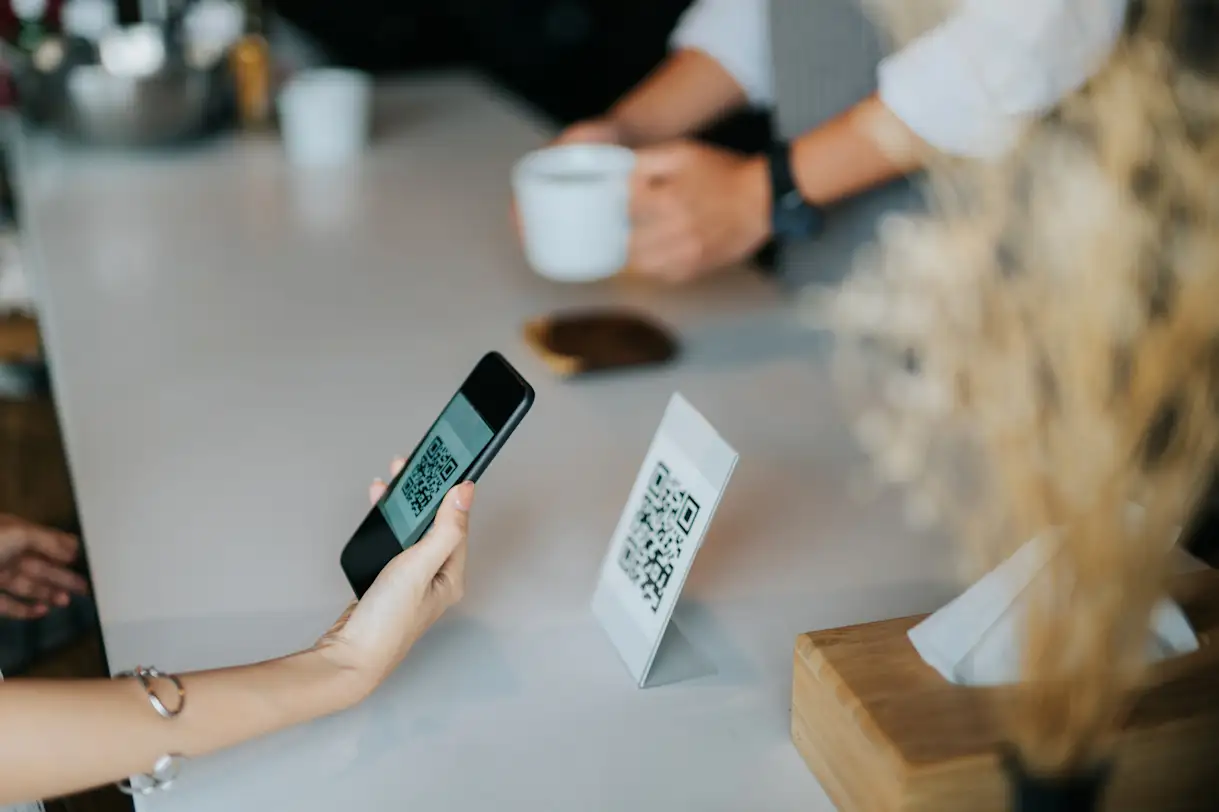 A person using their mobile device to scan a QR code