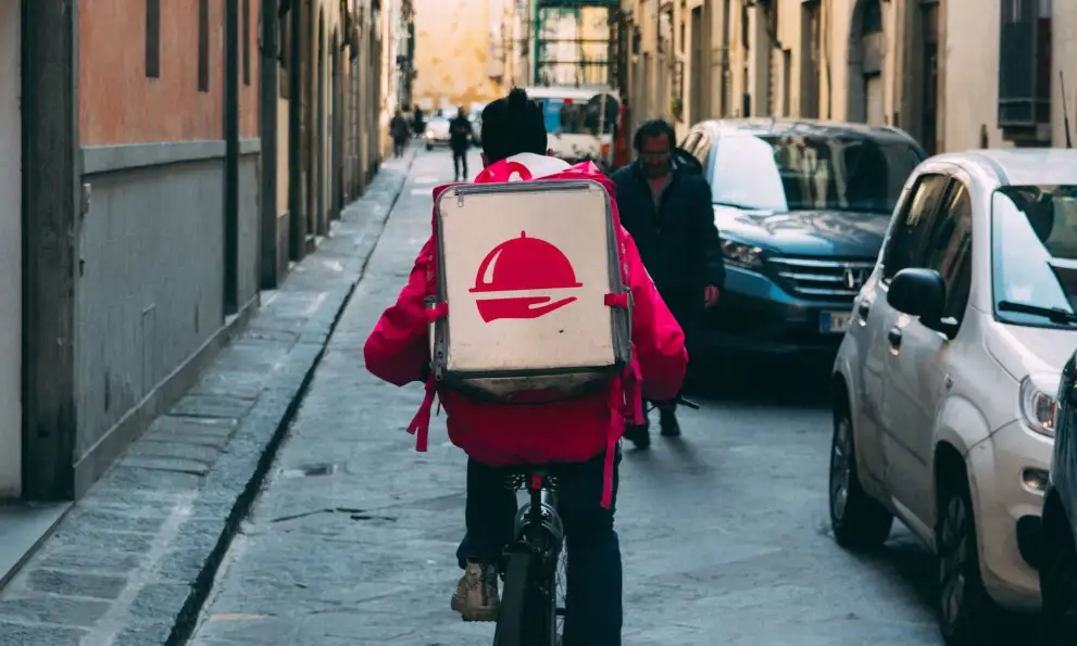 a delivery person on a bike.