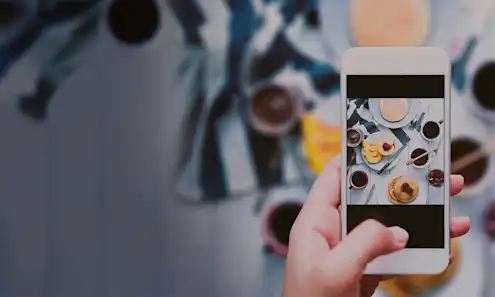 a hand holding a mobile phone