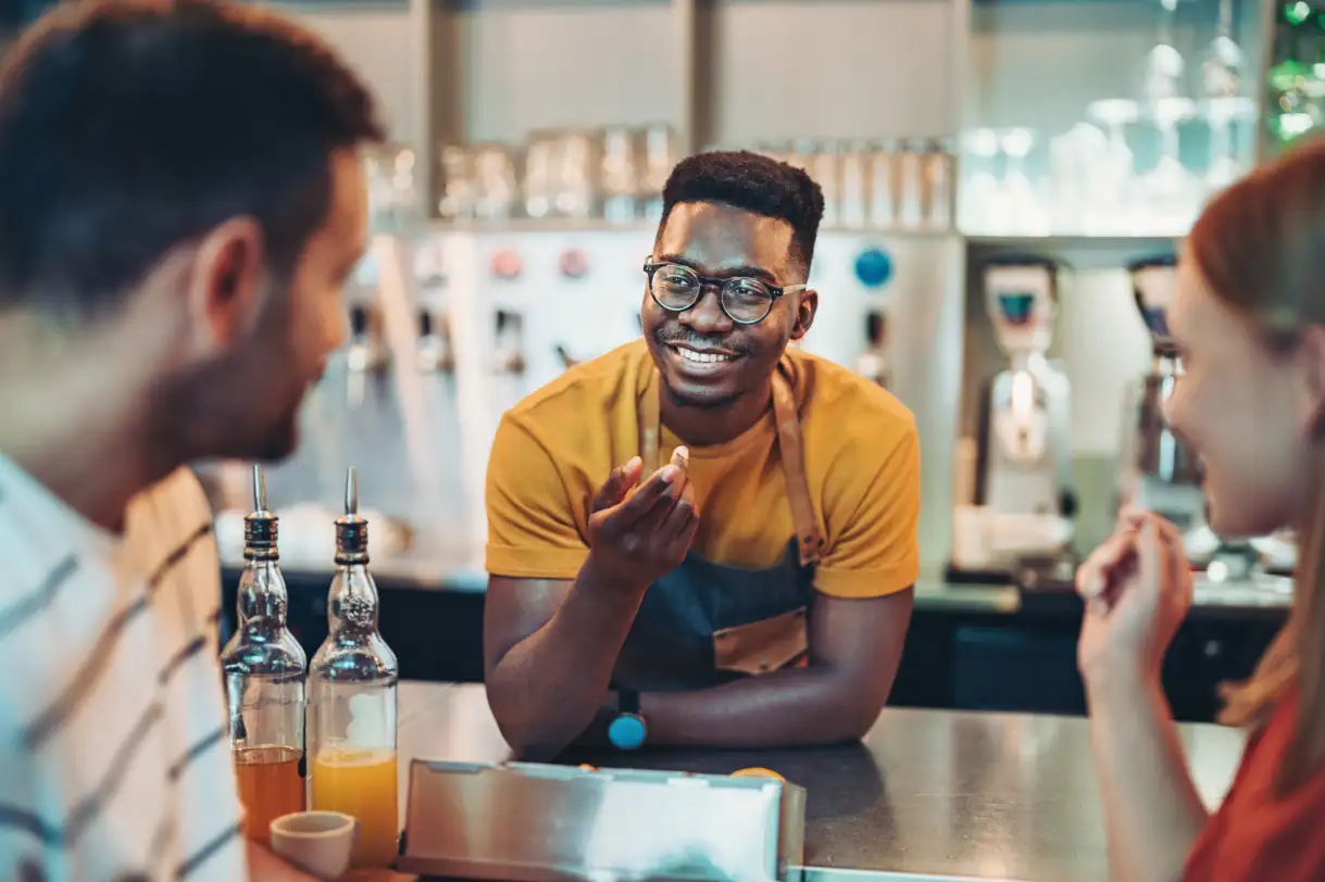 a person sitting at a table with wine glasses