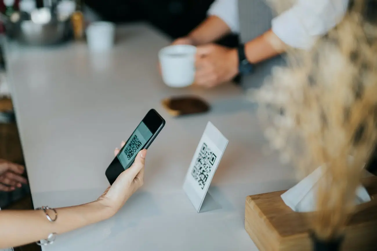 A person using their mobile device to scan a QR code