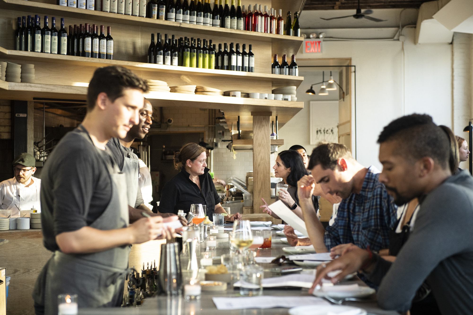 a group of people sitting at a table with wine glasses