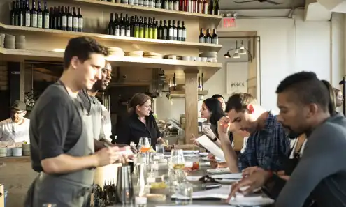 a group of people sitting at a table with wine glasses