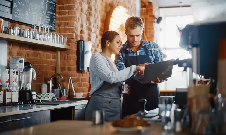 a man and woman standing in front of a table