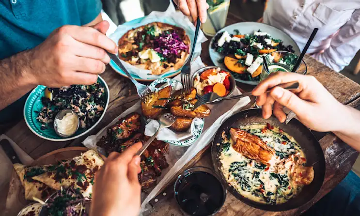 Friends enjoying a shared lunch at a restaurant