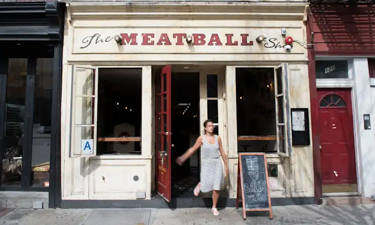 a person standing in front of a store