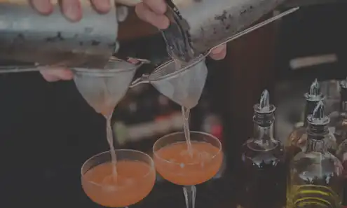 a hand holding a glass of wine