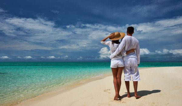 Couple walking on a white-sand beach