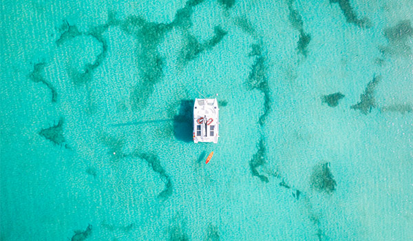 Aerial view of a catamaran in the middle of a coral reef