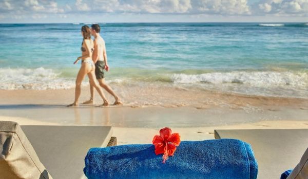 Terrasse privée dotée d’une piscine à débordement surplombant la mer lors d’une journée ensoleillée