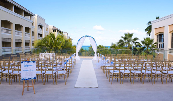 Wedding ceremony on a terrace surrounded by palm trees