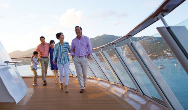 Multi-generational family walking along the ship's boardwalk