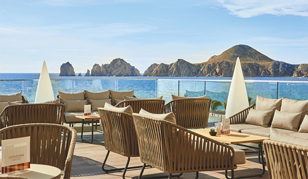 Patio with tables and chairs overlooking the rocky coast