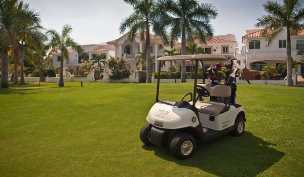 Golf cart sitting on pristine greens