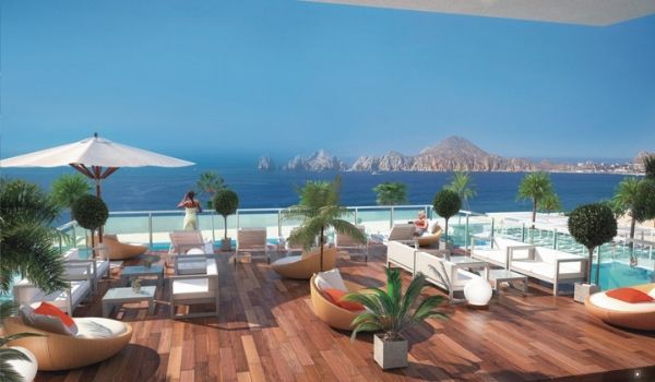 Rooftop lounge with infinity pool overlooking Los Cabos Arch