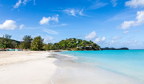Waves lapping onto the shores at Jolly Beach in Antigua