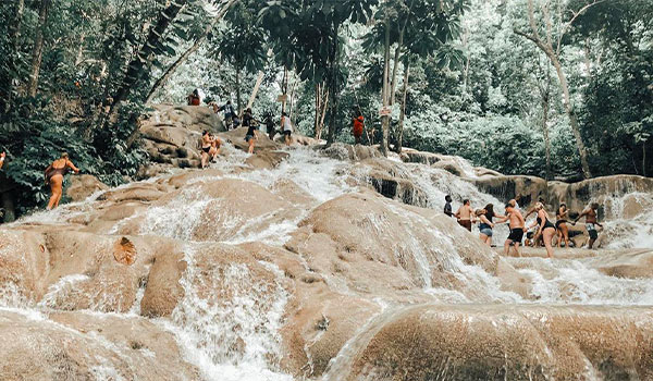 Group of people climbing up Dunn's River Falls