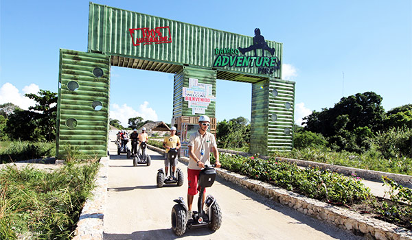Group of people riding segways along a path
