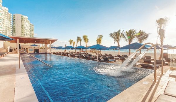 Infinity pool overlooking white-sand beach