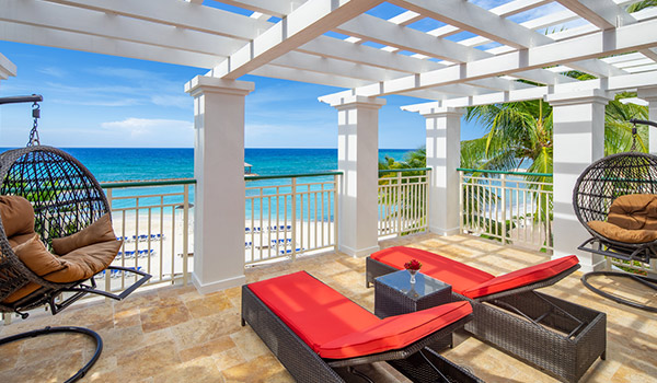 Lounge chairs on a terrace overlooking the beach and the ocean