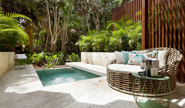 Patio with a private plunge pool surrounded by lush jungle landscapes