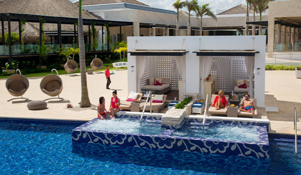 Vacationers lounging in a private luxury cabana with Jacuzzi
