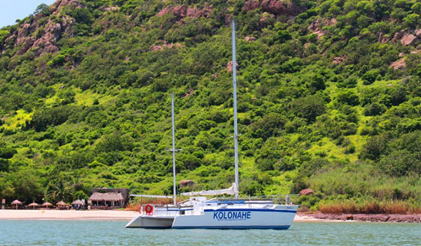Boat anchored off the beach of a lush island