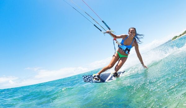 Woman smiling while parasailing on the ocean