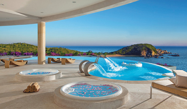 Hot tubs with rose petals and relaxing infinity pool overlooking the coast