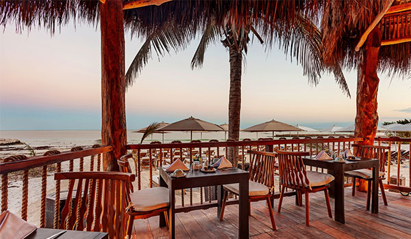 Al fresco restaurant overlooking the beach at sunset