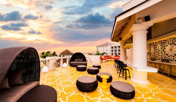 Rooftop lounge with Moroccan-inspired decor at sunset