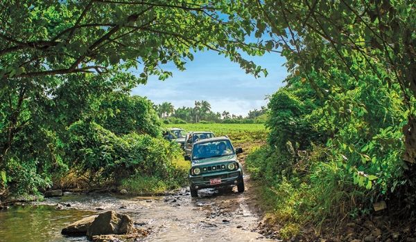 Jeep crossing a river in the countryside