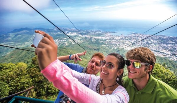 Three people taking a selfie during a cable car ride