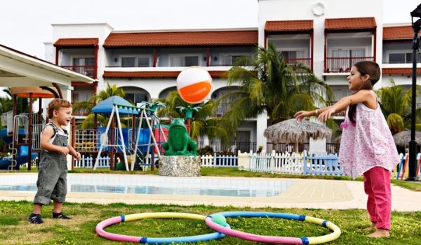 Deux jeunes enfants jouent avec un ballon au miniclub