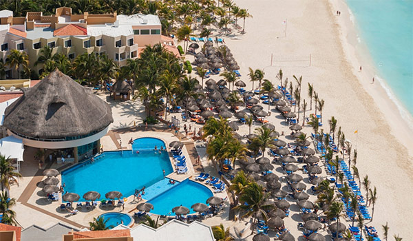 Aerial view of sparkling pool and beachfront at Viva Wyndham Maya