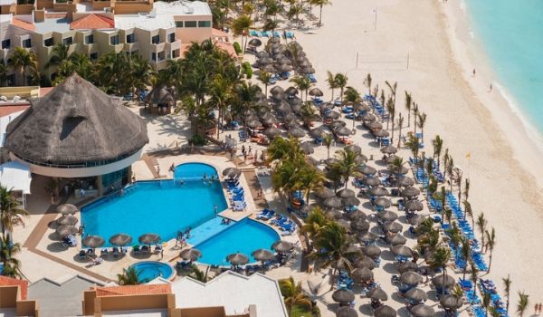 Aerial view of sparkling pool and beachfront at Viva Wyndham Maya