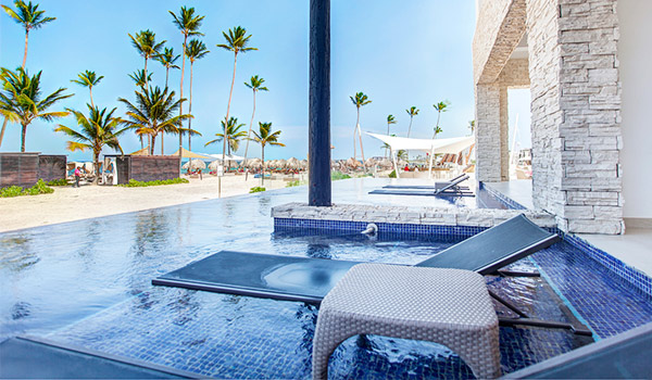Lounger and side table in a swim-out pool overlooking the beach