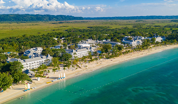 Aerial view of a beach resort surrounded by mountains