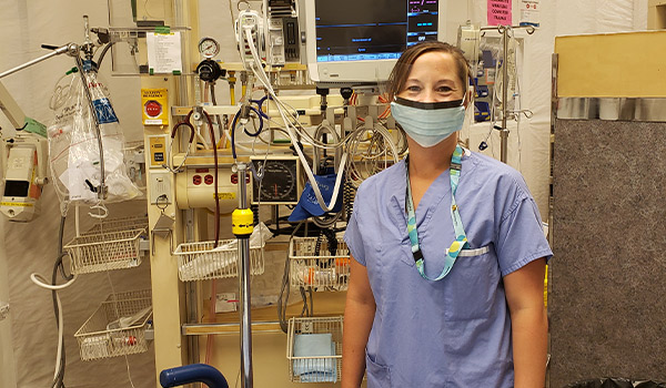 Nurse in uniform standing in a hospital room