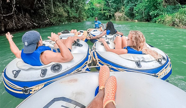 People floating down a river in inflatable tubes