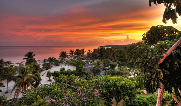 Tropical scenery in Holguin with turquoise waters. white-sand shores and lush green forests