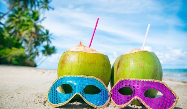 Pair of masks in front of coconuts