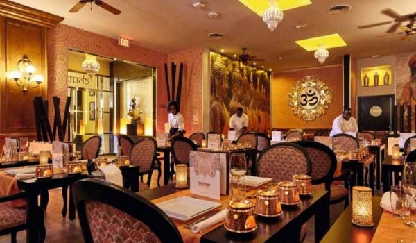 Indian-themed restaurant with candle votives and gold décor