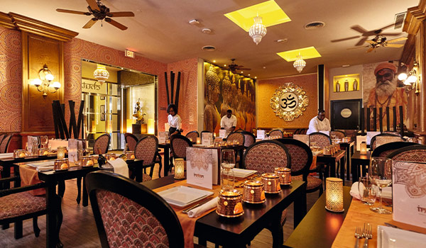 Indian-themed restaurant with candle votives and gold décor