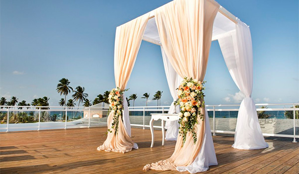 Wedding ceremony on a rooftop patio overlooking the beach